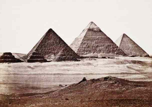The Giza Pyramids rise like mountains from the desert.